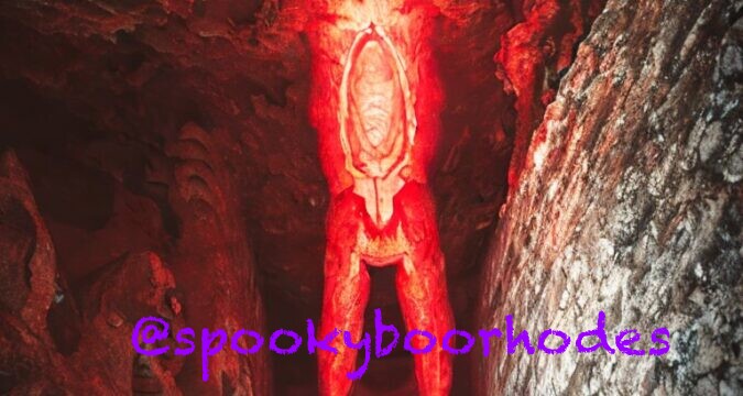 creepy red demon in a cave